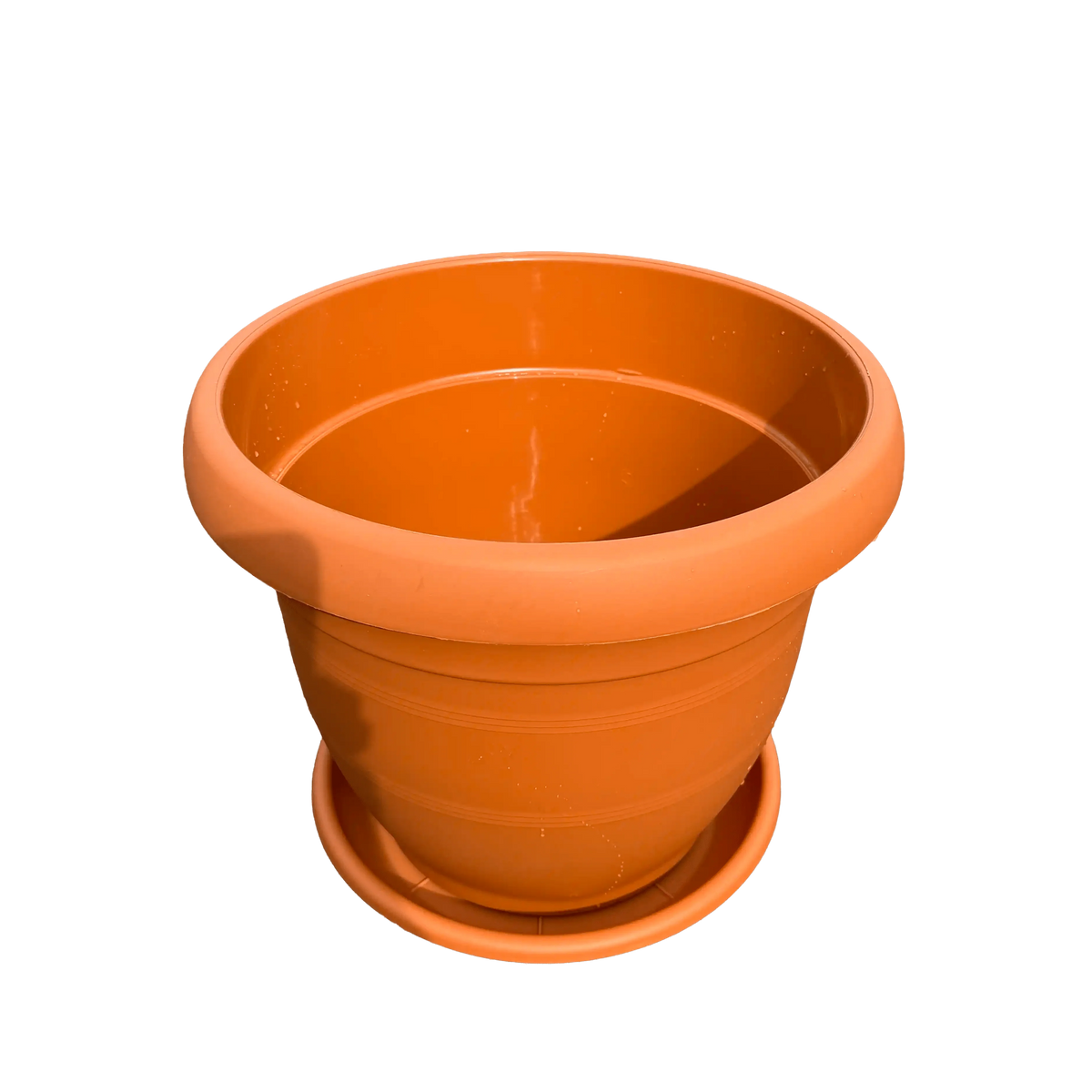 plastic pot with saucer on a white background